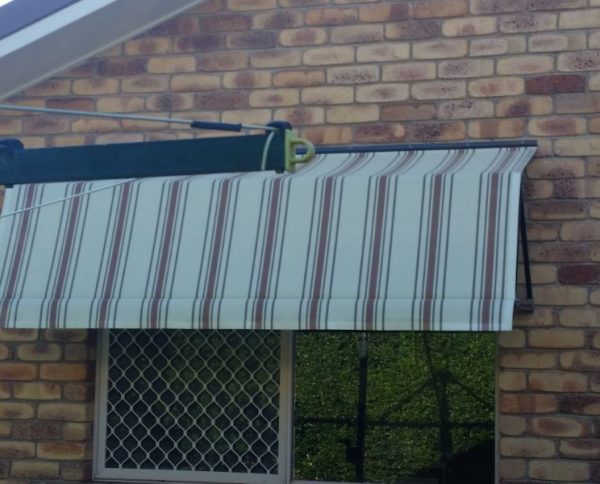 Awnings On The Window of Brick Home