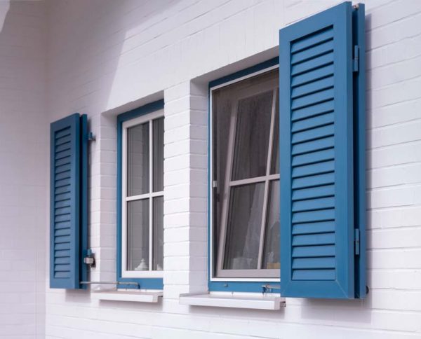 Blue Wooden Shutters On White Wall