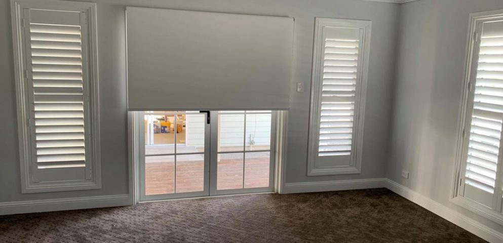 A Room With White Roller Blinds