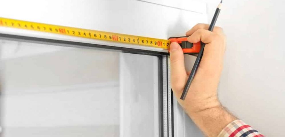 Man Measuring Window For Blinds